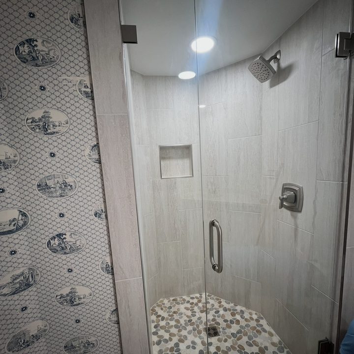 Custom-tile walk-in shower with a patterned accent wall