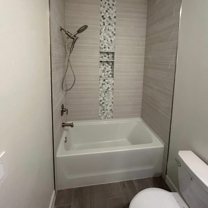 Tub and shower combo remodel with a mosaic accent