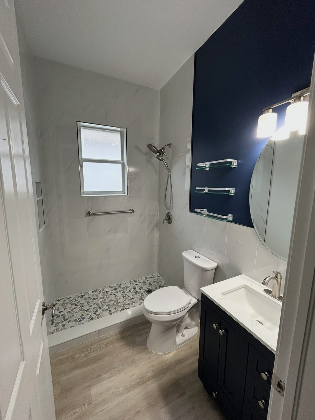 Completed bathroom remodel with a walk-in shower and vanity