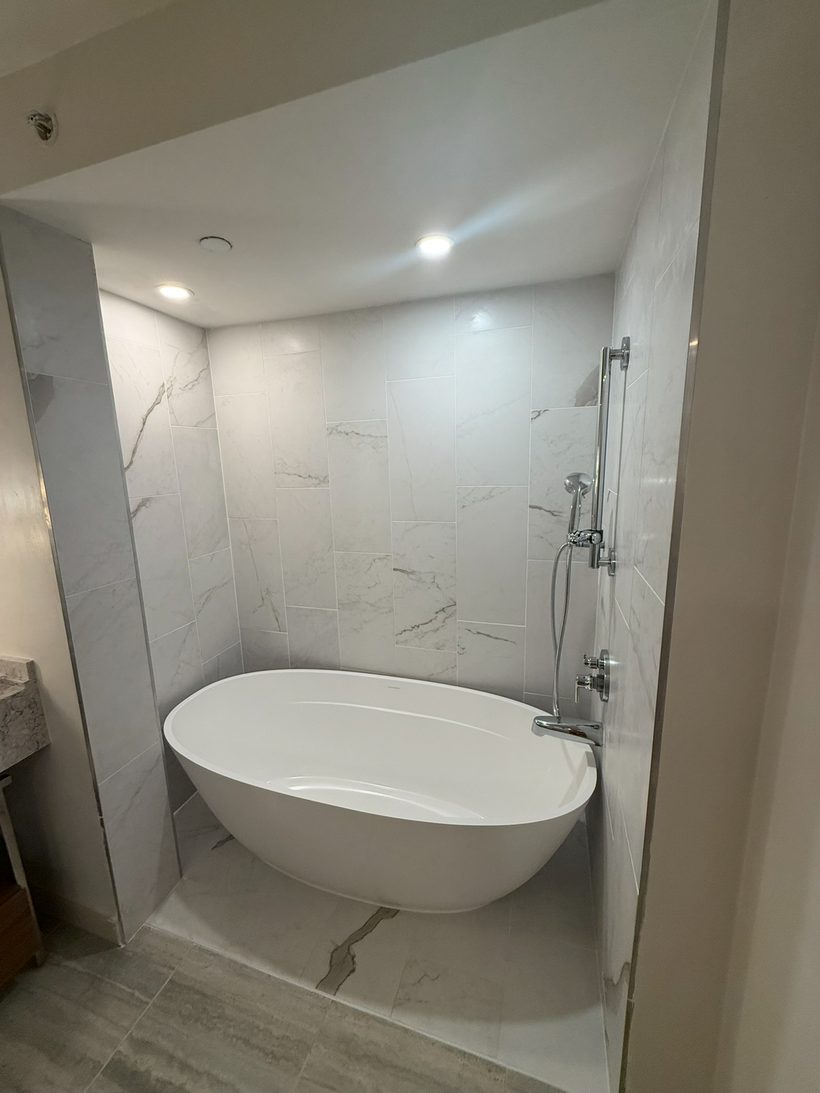 Freestanding soaking tub from a shower-to-tub conversion