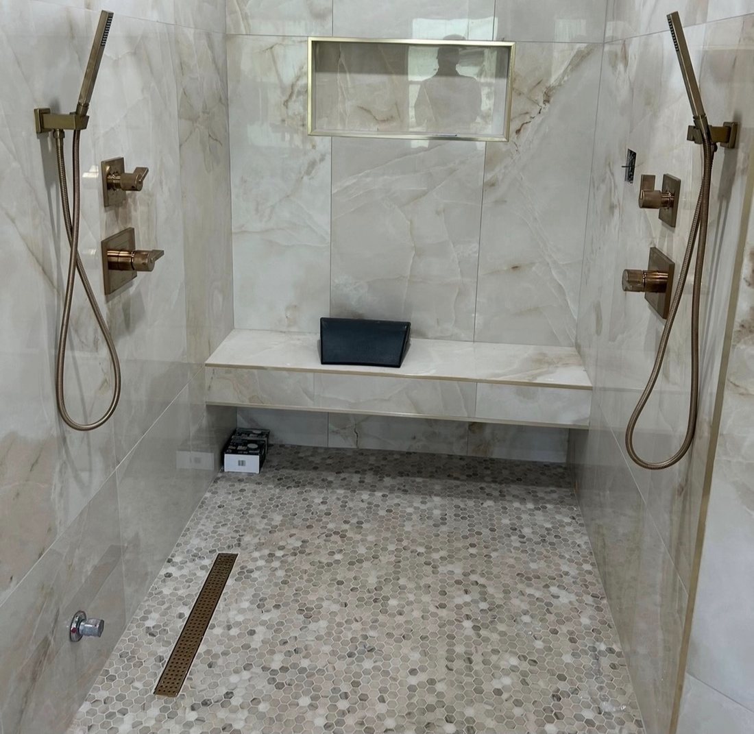 Walk-in shower with grab bars and a built-in bench